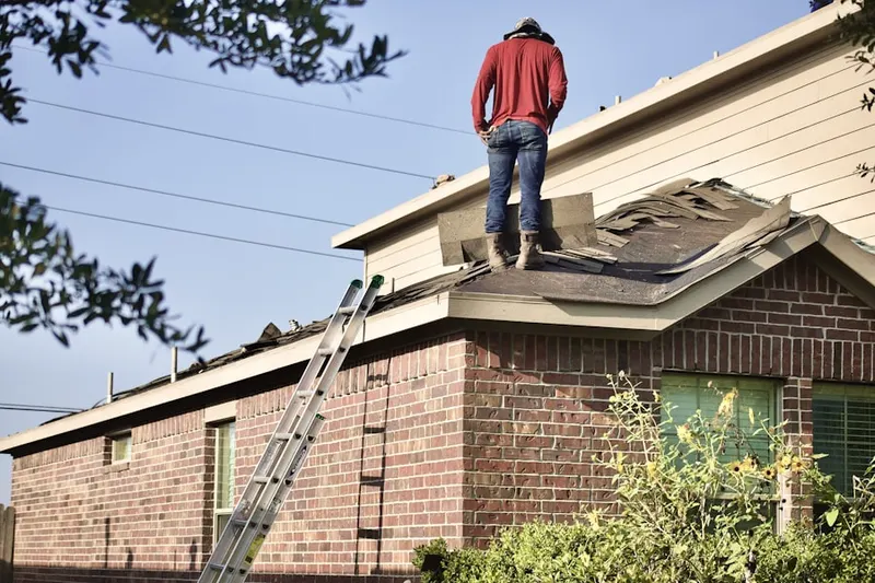 Professional roofer working on a residential roof in Jbsa Randolph